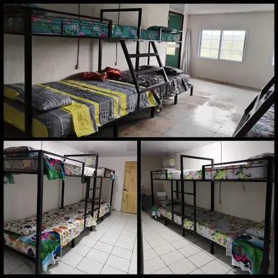 two pictures of a room with bunk beds in it at Hostel La Bambú in Quepos