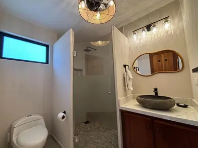 a bathroom with a sink and a toilet and a mirror at Stunning Ocean View Villa in Playa Coco and Ocotal in Ocotal