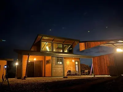 a house is lit up at night at Paraiso Terrenal Chalet in San Isidro