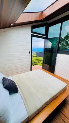 a large bed in a room with a large window at Paraiso Terrenal Chalet in San Isidro