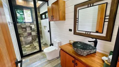 a bathroom with a sink and a mirror at Paraiso Terrenal Chalet in San Isidro