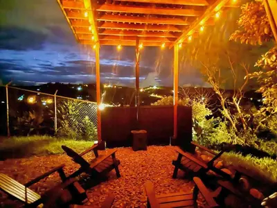 a group of benches sitting under a pergola at night at Paraiso Terrenal Chalet in San Isidro