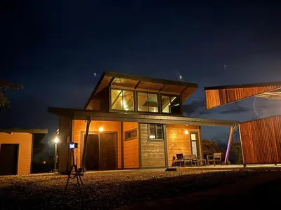 a house is lit up at night at Paraiso Terrenal Chalet in San Isidro
