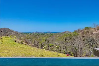 a view from the top of a hill with a swimming pool at Luxury villa Potrero in Potrero