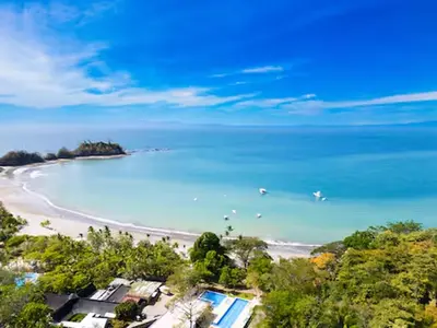 an aerial view of a beach with boats in the water at Playa Mantas - 7th Floor - Sea View - Beach Club Access - Balcony - Beach in Punta Leona