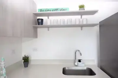 a kitchen counter with a sink and a shelf at Playa Mantas - 7th Floor - Sea View - Beach Club Access - Balcony - Beach in Punta Leona