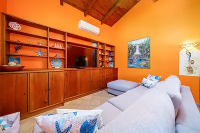 a living room with a couch and a television at BBQ, Pool, Garden, Smart TV, Parking, AC, King Bed, Laundry facilities - Villaggio 376 in Potrero