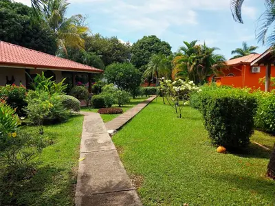 a garden with a path leading to a house at BBQ, Pool, Garden, Smart TV, Parking, AC, King Bed, Laundry facilities - Villaggio 376 in Potrero