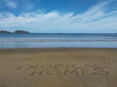 a sign written in the sand on the beach at BBQ, Pool, Garden, Smart TV, Parking, AC, King Bed, Laundry facilities - Villaggio 376 in Potrero