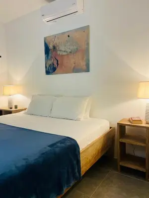a bedroom with a bed and a painting on the wall at Peaceful house in nature 5 min drive from beach in San Juanillo