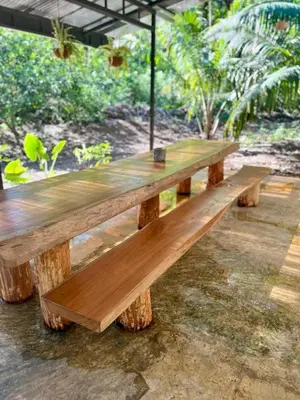 a wooden picnic table sitting on top of logs at Peaceful house in nature 5 min drive from beach in San Juanillo