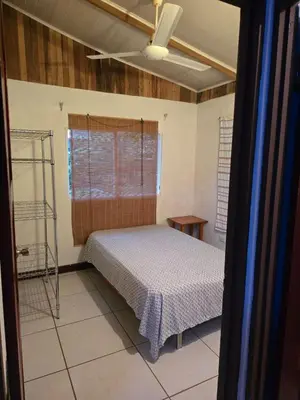 a bedroom with a bed in a room at Casa Tica in Playa Flamingo