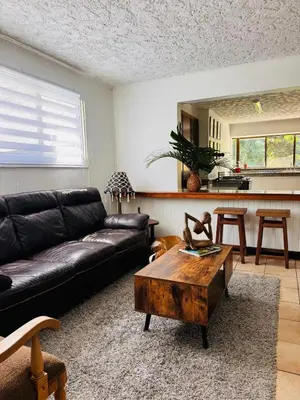 a living room with a couch and a coffee table at Bonsai House in Brasil