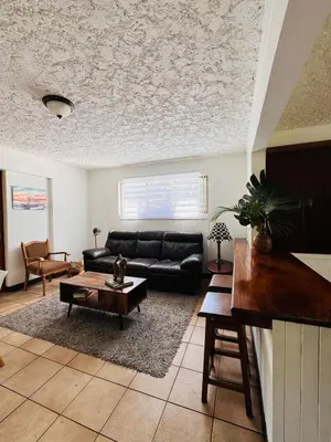 a living room with a couch and a table at Bonsai House in Brasil