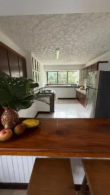 a kitchen with a counter top with fruit on it at Bonsai House in Brasil