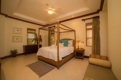 a bedroom with a canopy bed and a fan at Bella Vista 2D 3 bdr 3 1 and half bath in La Mona