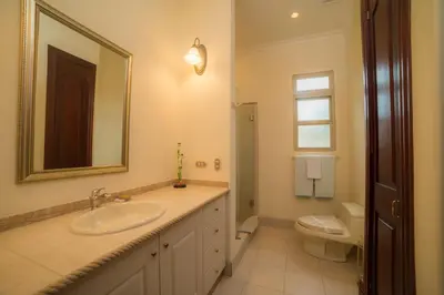a bathroom with a sink and a toilet and a mirror at Bella Vista 2D 3 bdr 3 1 and half bath in La Mona