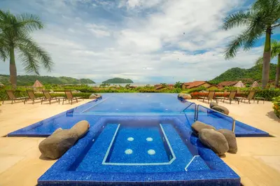 a swimming pool in the middle of a resort at Miramar 4E - 3 bdr 3 bath Ocean View in Herradura