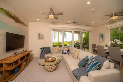 a living room with a couch and a television at Miramar 4E - 3 bdr 3 bath Ocean View in Herradura