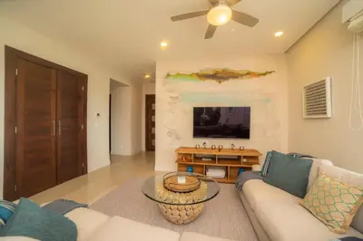 a living room with a couch and a table at Miramar 4E - 3 bdr 3 bath Ocean View in Herradura