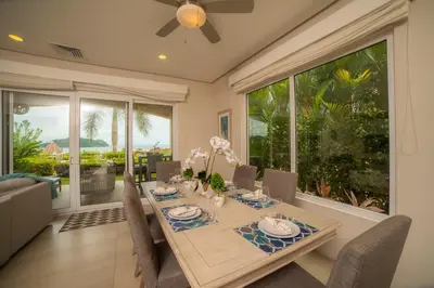 a dining room with a table and a large window at Miramar 4E - 3 bdr 3 bath Ocean View in Herradura