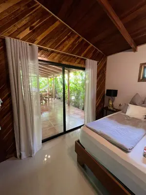 a bedroom with a bed and a view of a patio at Casa Adam in Pochote