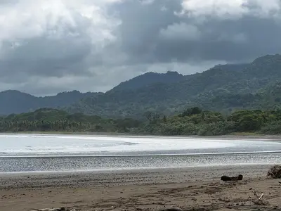 a sandy beach with mountains in the background at Casa Adam in Pochote
