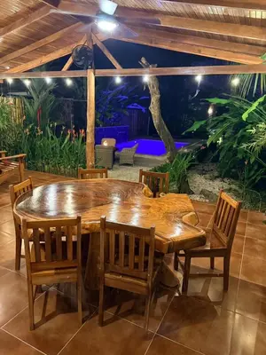 a wooden table and chairs in a patio at Casa Adam in Pochote