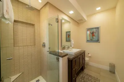 a bathroom with a glass shower and a sink at Miramar 3B - 3 bedr 3 bath Ocean View in Herradura