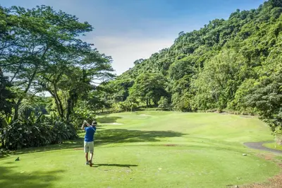 a man standing on a golf course looking at a green at Miramar 3B - 3 bedr 3 bath Ocean View in Herradura
