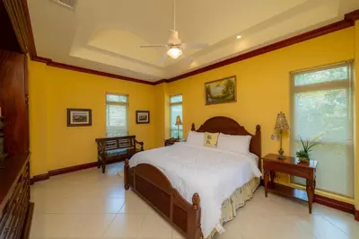a bedroom with a bed and yellow walls at Bella Vista 8B 3 bedr 3 1 and half bath in Jacó