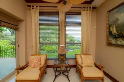two chairs and a table in a room with a window at Bella Vista 8B 3 bedr 3 1 and half bath in Jacó