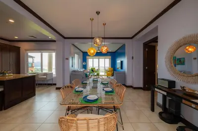 a dining room and living room with a table and chairs at Altavista 4C 3 bdr 3 bath Ocean View in La Mona
