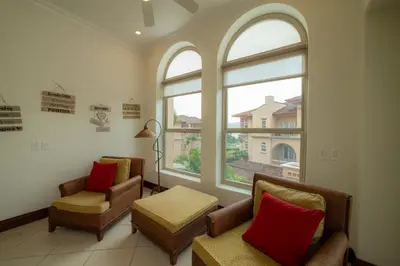 a waiting room with two chairs and two windows at Bella Vista 1C - 3 bdr - 3 1 and half bath in La Mona