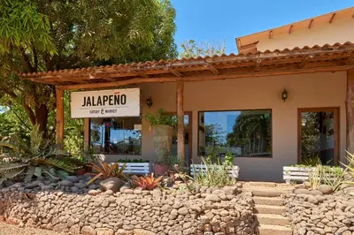 a building with a sign for a mariposa restaurant at Playa Negra Surf Lodge in Playa Negra