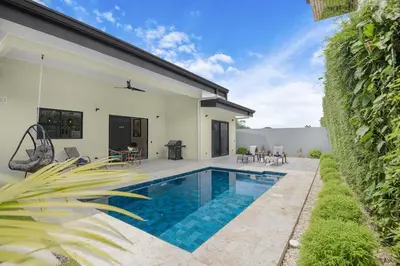 a swimming pool in the backyard of a house at Brand New Villa! - Just 10 Mins Walk To The Beach in Uvita