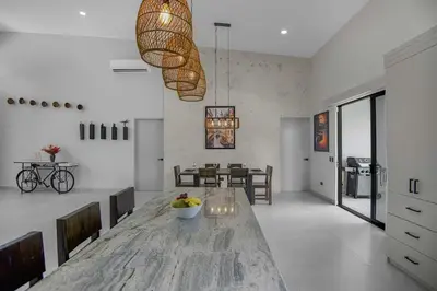 a living room with a table and a dining room at Brand New Villa! - Just 10 Mins Walk To The Beach in Uvita