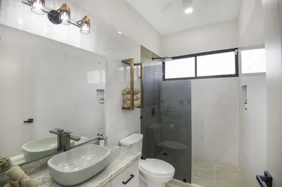 a bathroom with a sink and a toilet and a shower at Brand New Villa! - Just 10 Mins Walk To The Beach in Uvita
