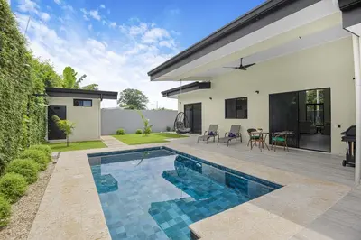 a swimming pool in the backyard of a house at Brand New Villa! - Just 10 Mins Walk To The Beach in Uvita