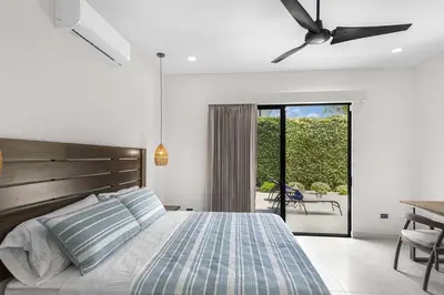 a bedroom with a bed and a ceiling fan at Brand New Villa! - Just 10 Mins Walk To The Beach in Uvita