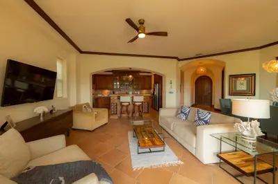 a living room with a couch and a ceiling fan at Montebello 4E 3bed 3 bath in Jacó