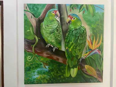 two green birds sitting on a tree branch at El Papagayo Verde 5 min walk to the beach and downtown in Coco