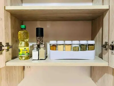 a shelf with spices and a bottle of oil at El Papagayo Verde 5 min walk to the beach and downtown in Coco