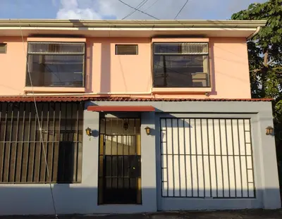 a house with a gate in front of it at Casa #4 Studios in San Pedro