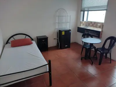 a bedroom with a bed and a table and chairs at Casa #4 Studios in San Pedro