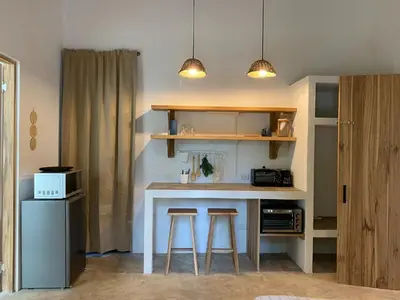 a kitchen with a counter and stools in a room at Modern Villa Exclusive Tropical Nature Retreat Rio Celeste 6 to 8 Guests in Upala