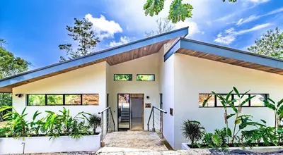 a white house with a blue roof at Modern Villa Exclusive Tropical Nature Retreat Rio Celeste 6 to 8 Guests in Upala