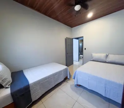 a bedroom with two beds in a room at Malani Lodge Tamarindo in Villarreal