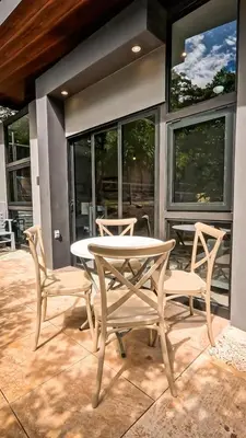 a table and two chairs on a patio at Malani Lodge Tamarindo in Villarreal