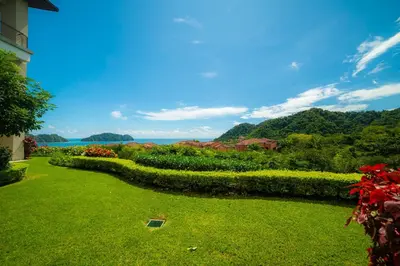 a garden with a view of the water and trees at Montecielo 3E - 3 bdr 3 1 and a half bath Ocean View in La Mona